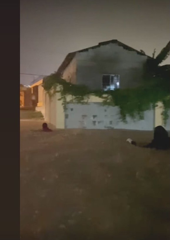 A home in Montellano with flood water rising against it at night.