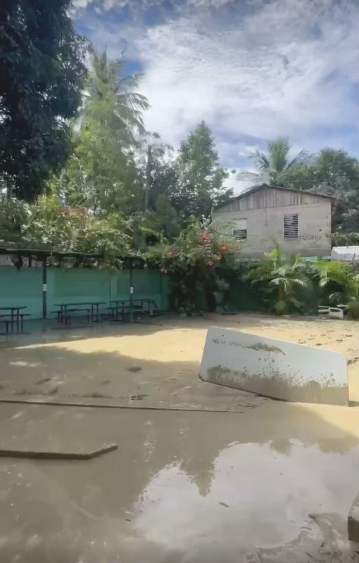 The school courtyard covered in mud and debris the morning after the flood.